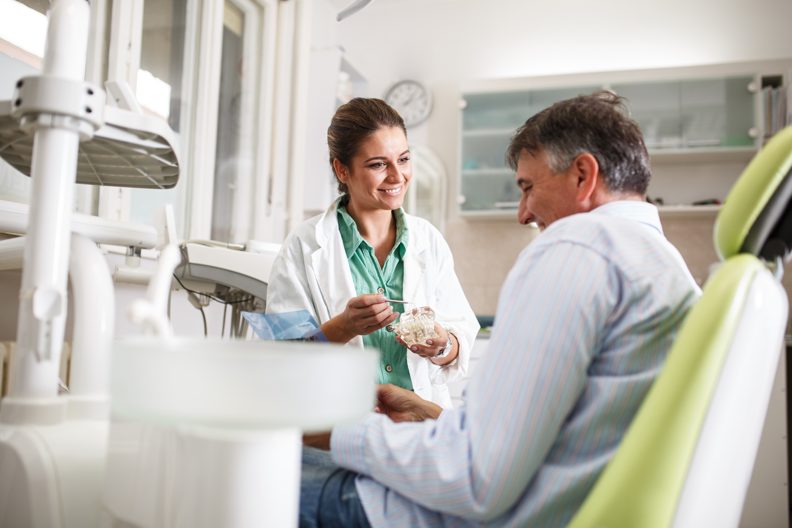 Dentist talking with patient